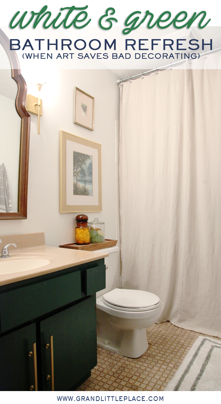 Bathroom painted white with green vanity gold hardware, vintage arched mirror, gold sconces, DIY drop cloth shower curtain and original artwork. Text overlay reads white and green bathroom refresh, when art helps bad decorating